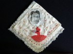 31.Theatrical_hankie_9x8.5_laser-print_acrylic_graphite_threads_glass-beads_batting-and-embroidery-floss-on-vintage-linen-handkerchief_7.5.2014_edited-1